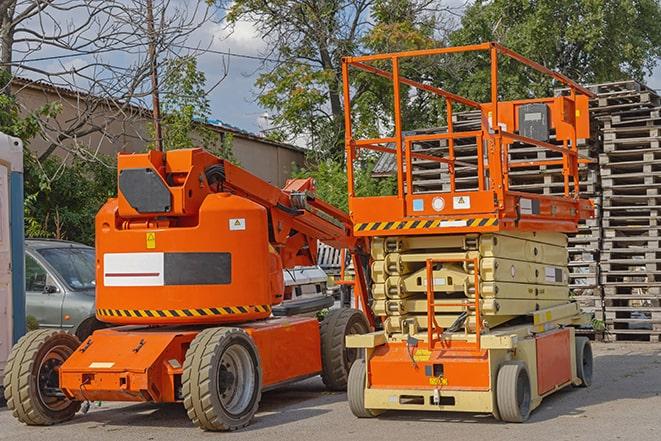 forklift carrying pallets in a busy warehouse in Crenshaw, MS